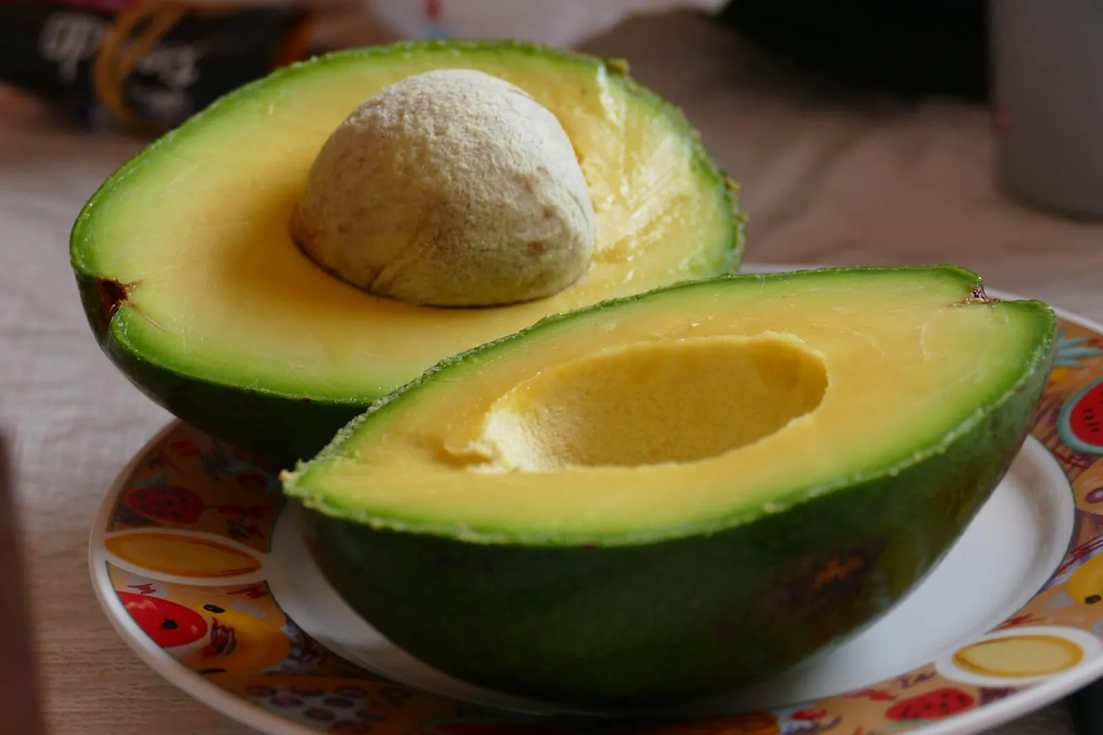 Fresh avocado cut in half on a counter