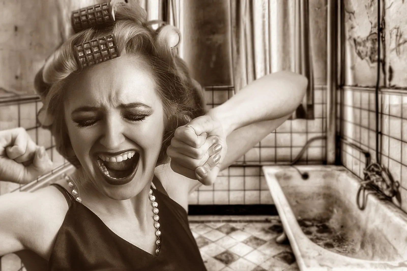 Woman gently unwinding a braid in front of a bathroom mirror to reveal soft waves