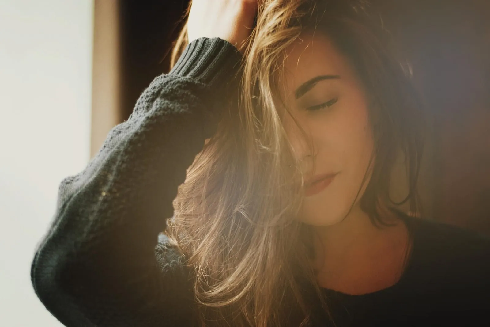 Woman with long brown hair in morning light, portrait