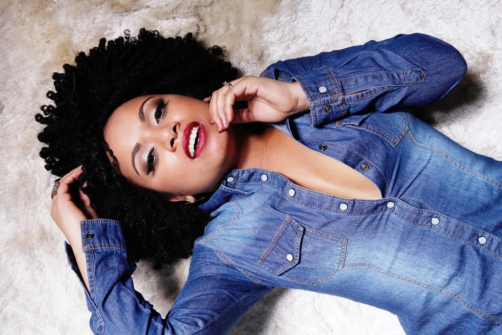 Woman with soft, defined curls and a relaxed smile