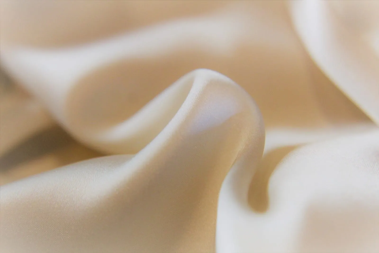 Close-up of smooth silk fabric with soft folds