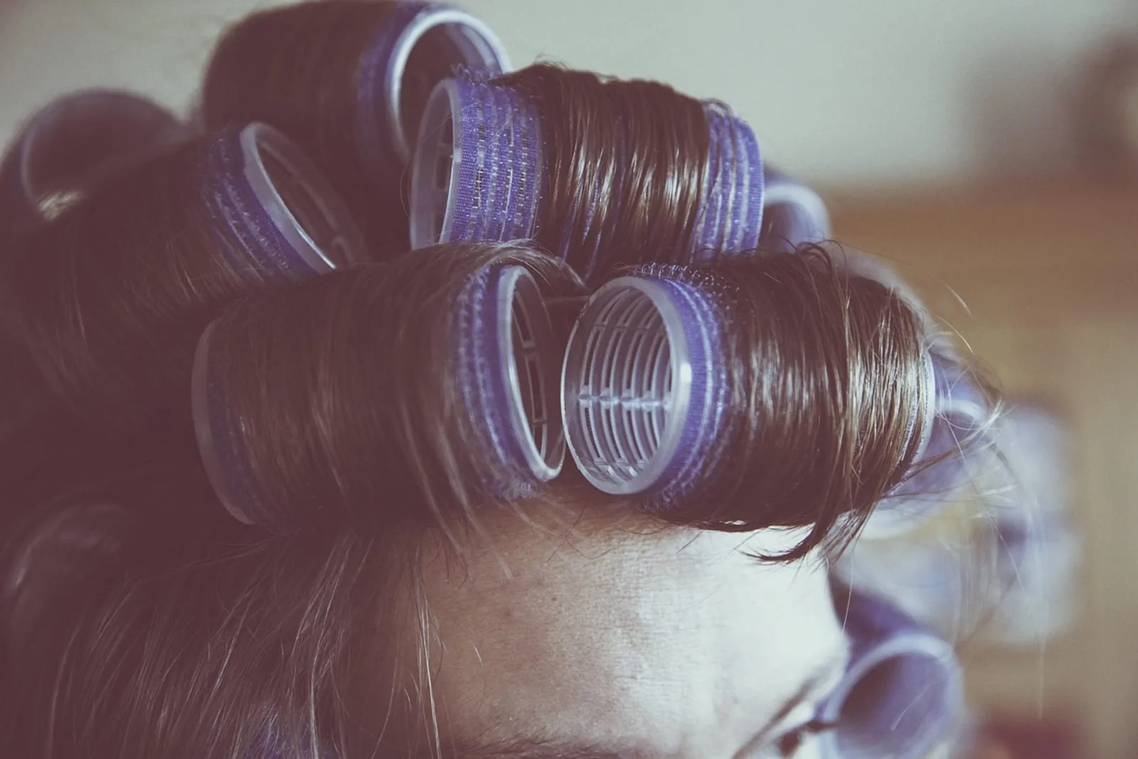 Hair wrapped in blue rollers, close up