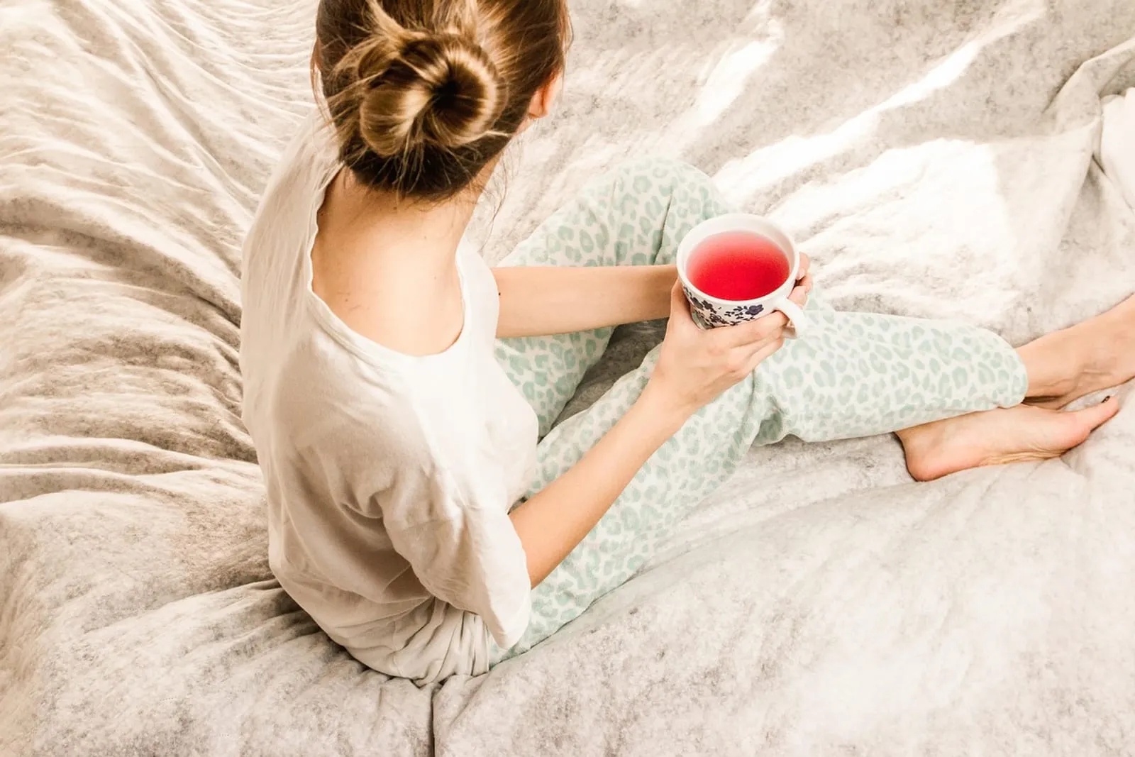 Woman relaxing in bed in the morning