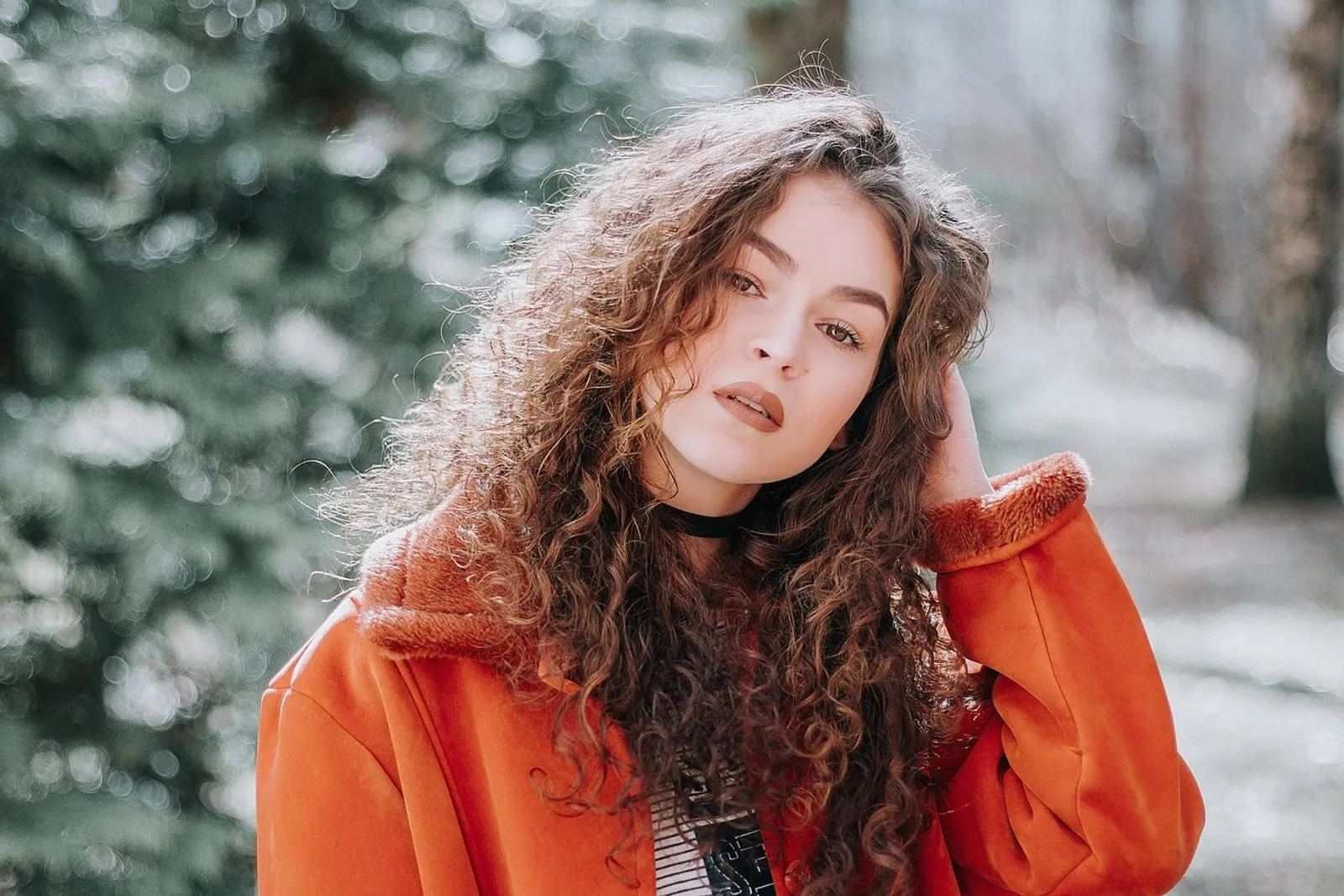 Woman with voluminous curly hair outdoors in natural light