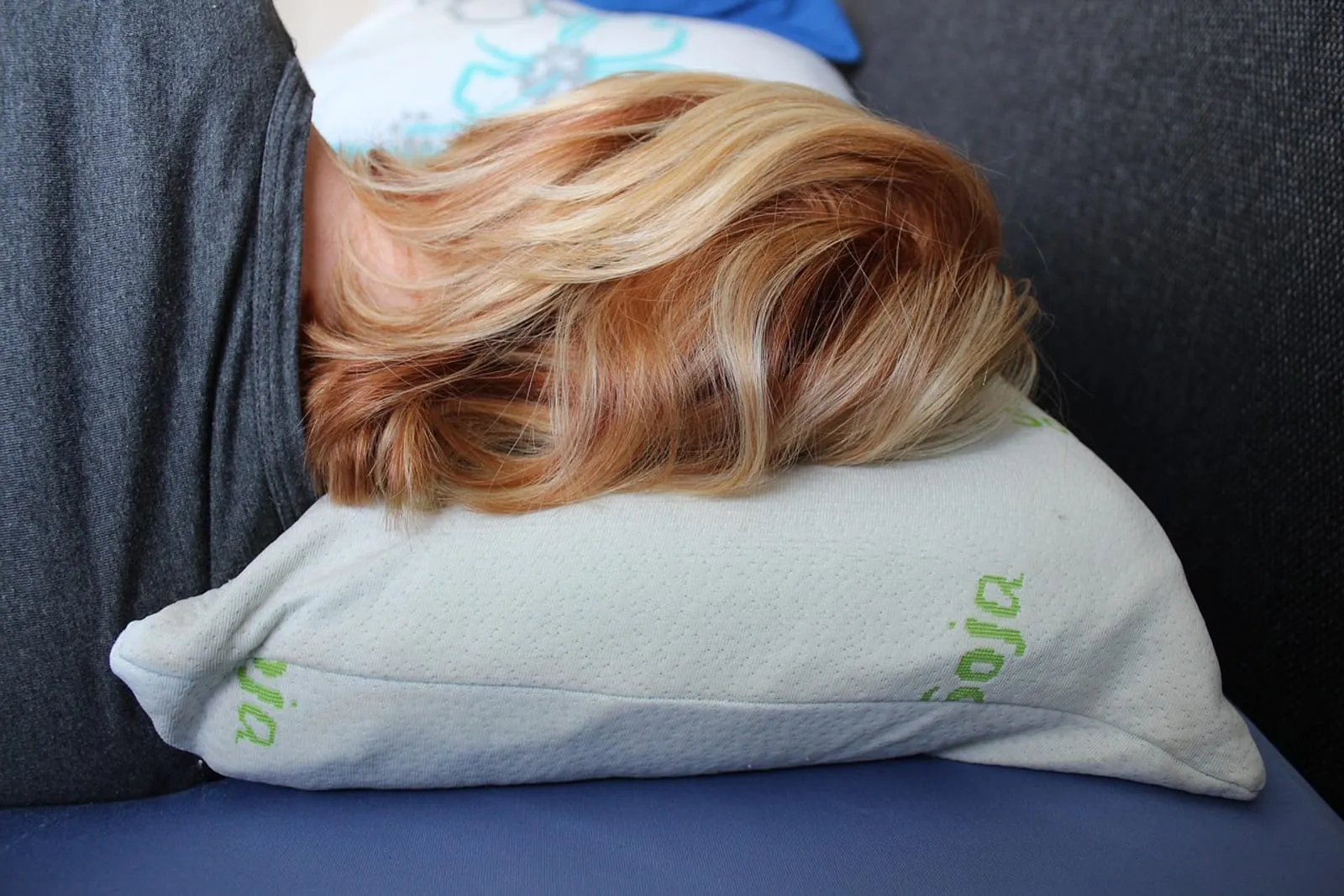 Woman lying with her blonde hair spread over a pillow