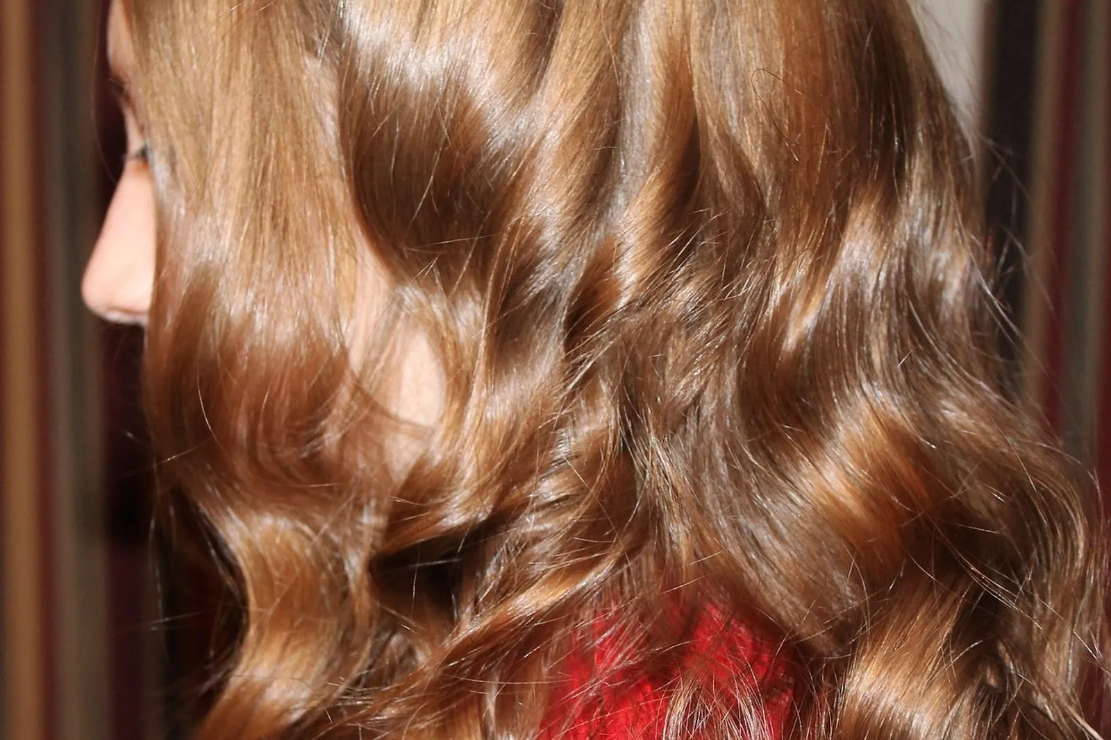 Close-up of long glossy brown waves of hair